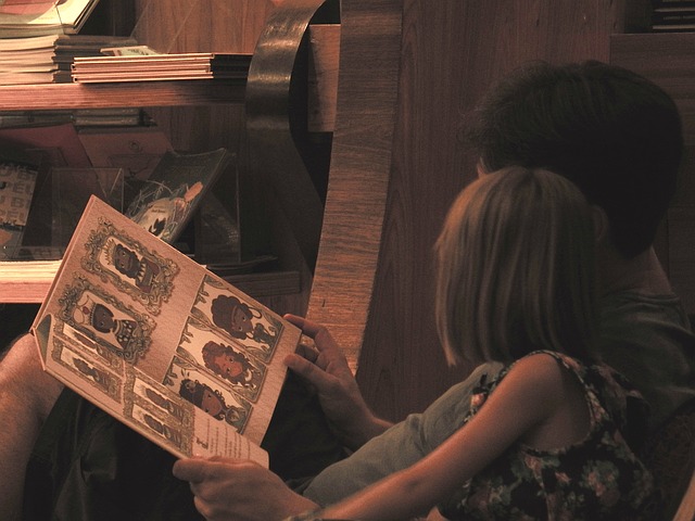 A child sits on an adults lap to read a story